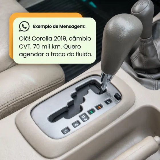 Alavanca de câmbio automático com um balão de exemplo de mensagem no WhatsApp: “Olá! Corolla 2019, câmbio CVT, 70 mil km. Quero agendar a troca do fluido.”